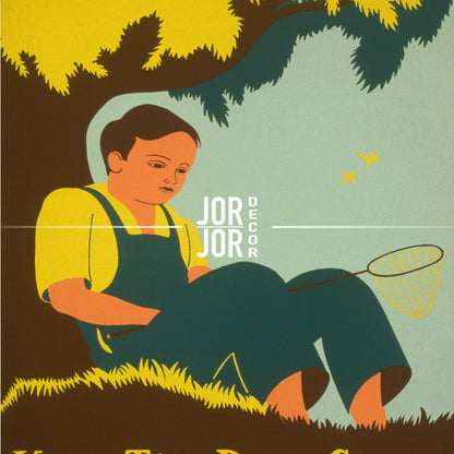 A man in overalls is sitting on the grass, holding a net and looking down at it.
